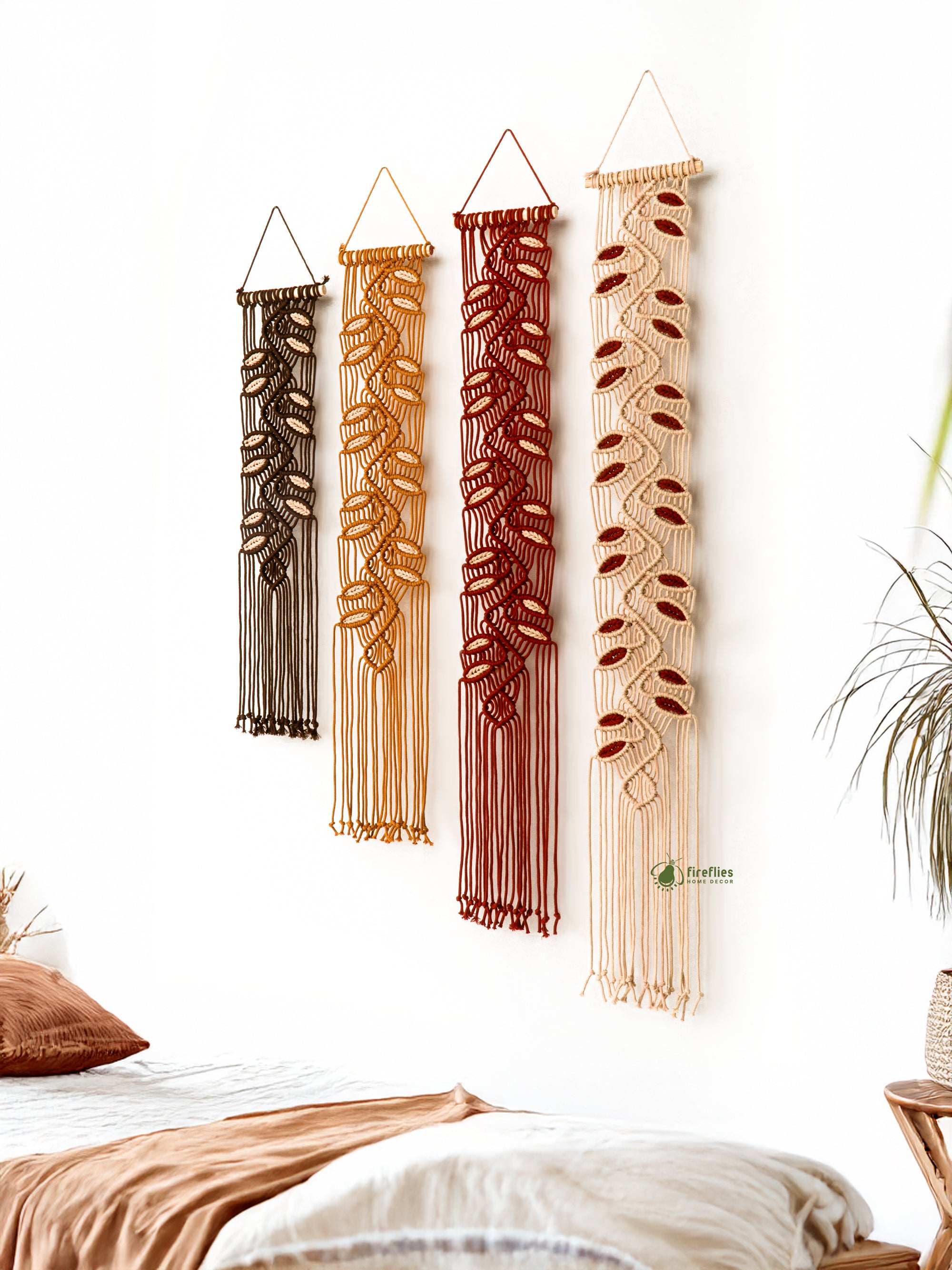 Set of four woven wall hangings in various shades of brown and beige on a white wall.