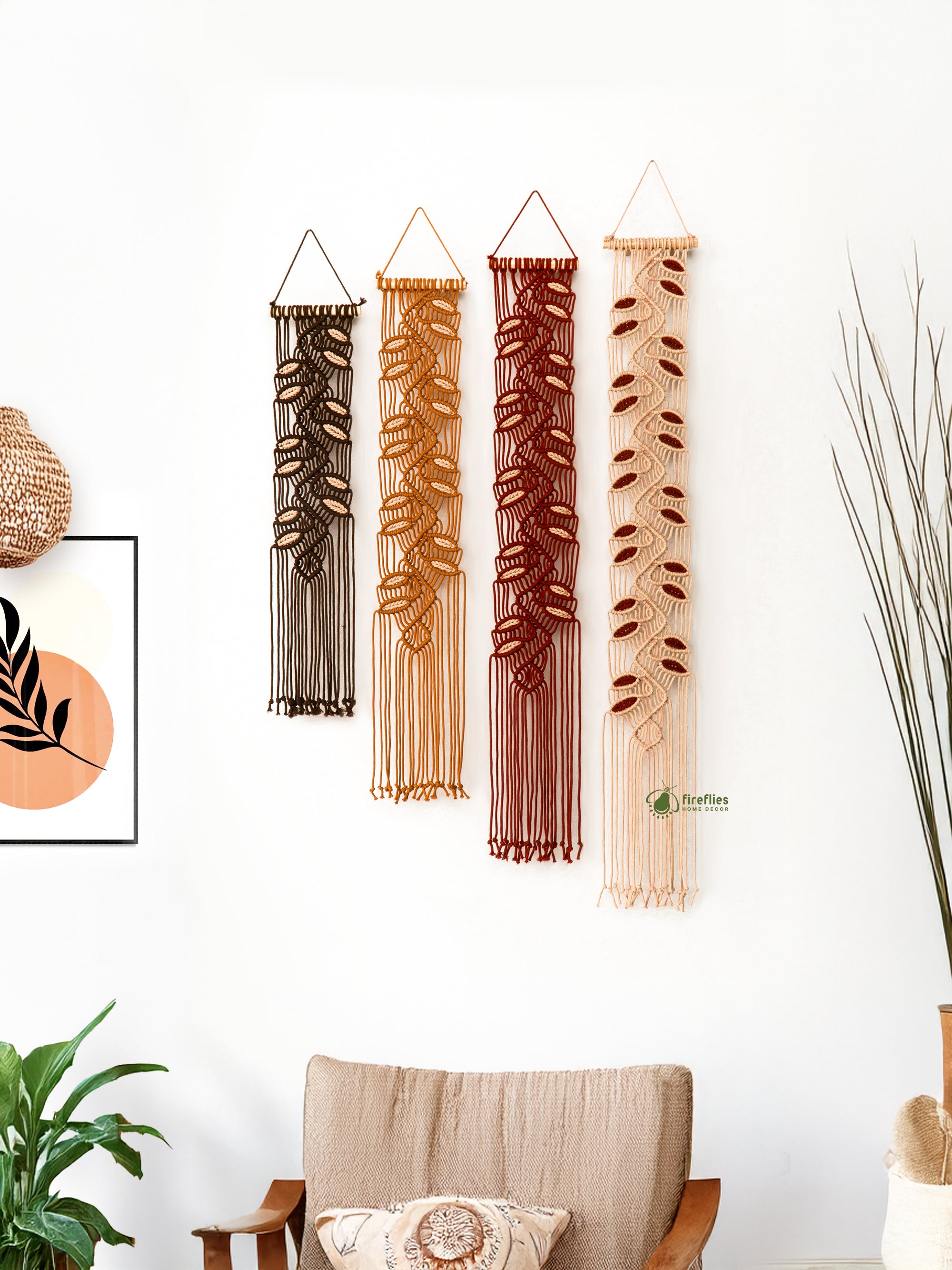 Set of four woven wall hangings in various earthy tones hanging on a white wall.