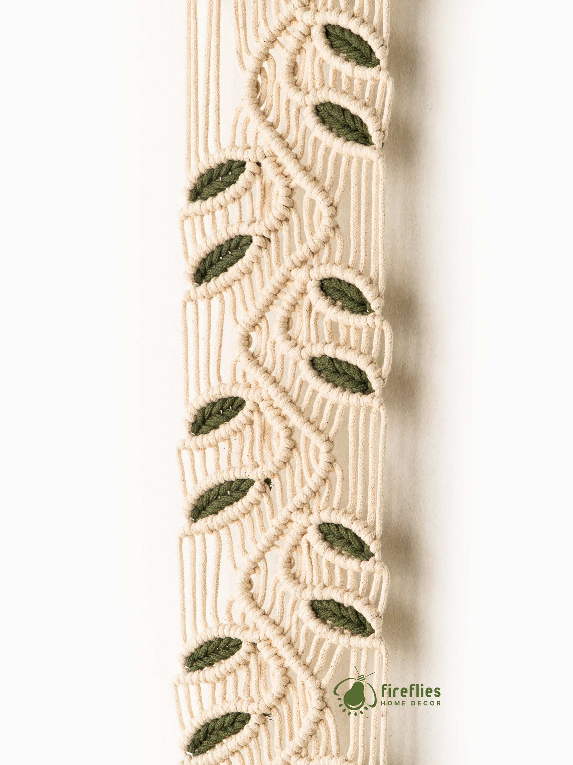 Brown woven wall art with fringe on a white background