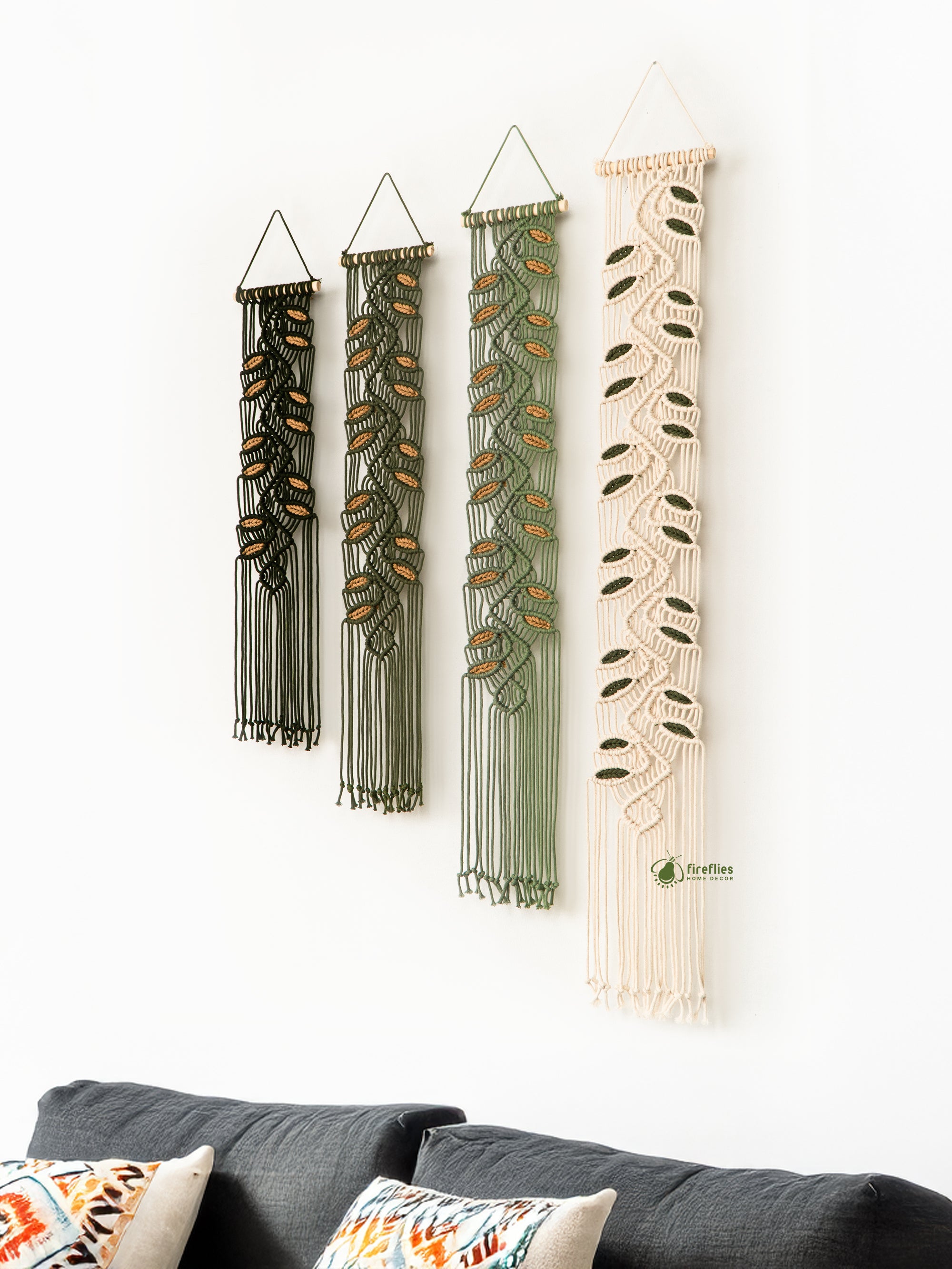 Set of four woven wall hangings in various shades of brown and beige on a white wall.