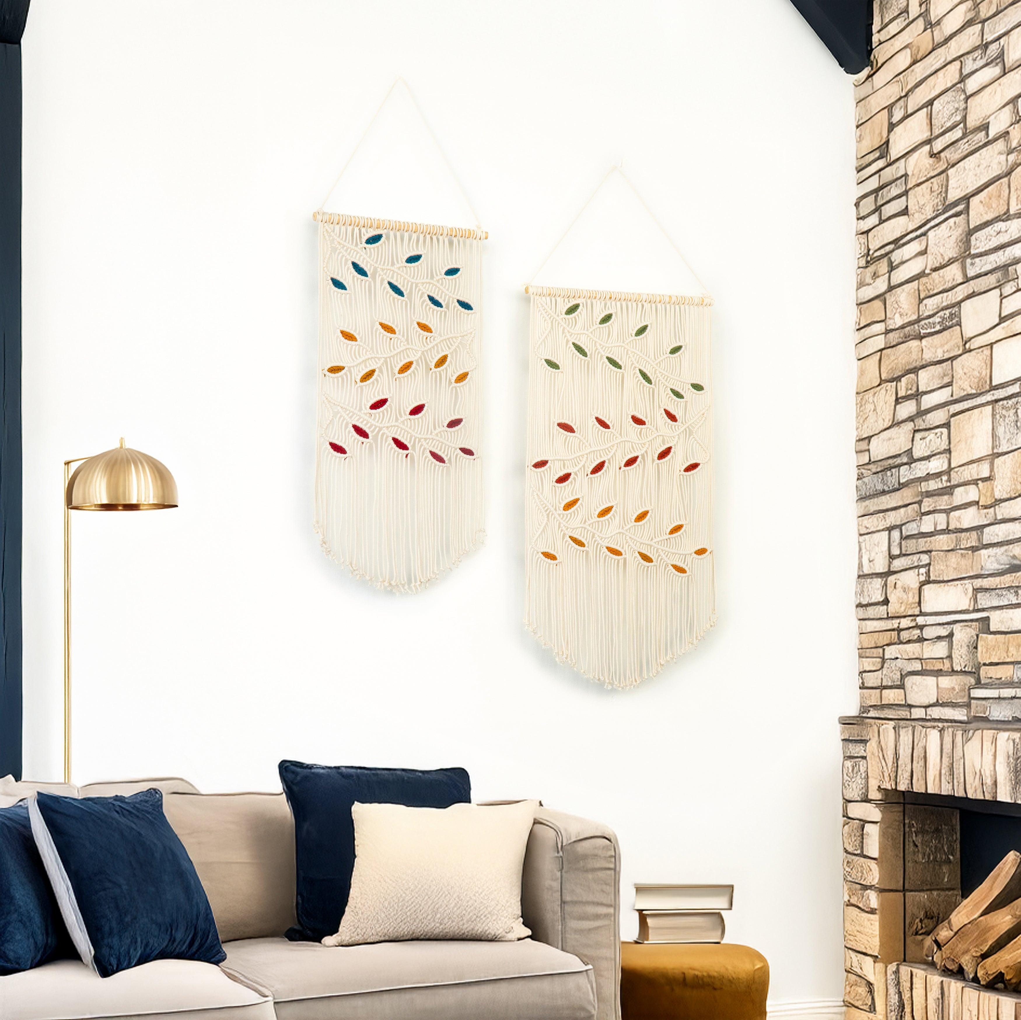 Living room with a stone fireplace, sofa with pillows, and wall hangings.