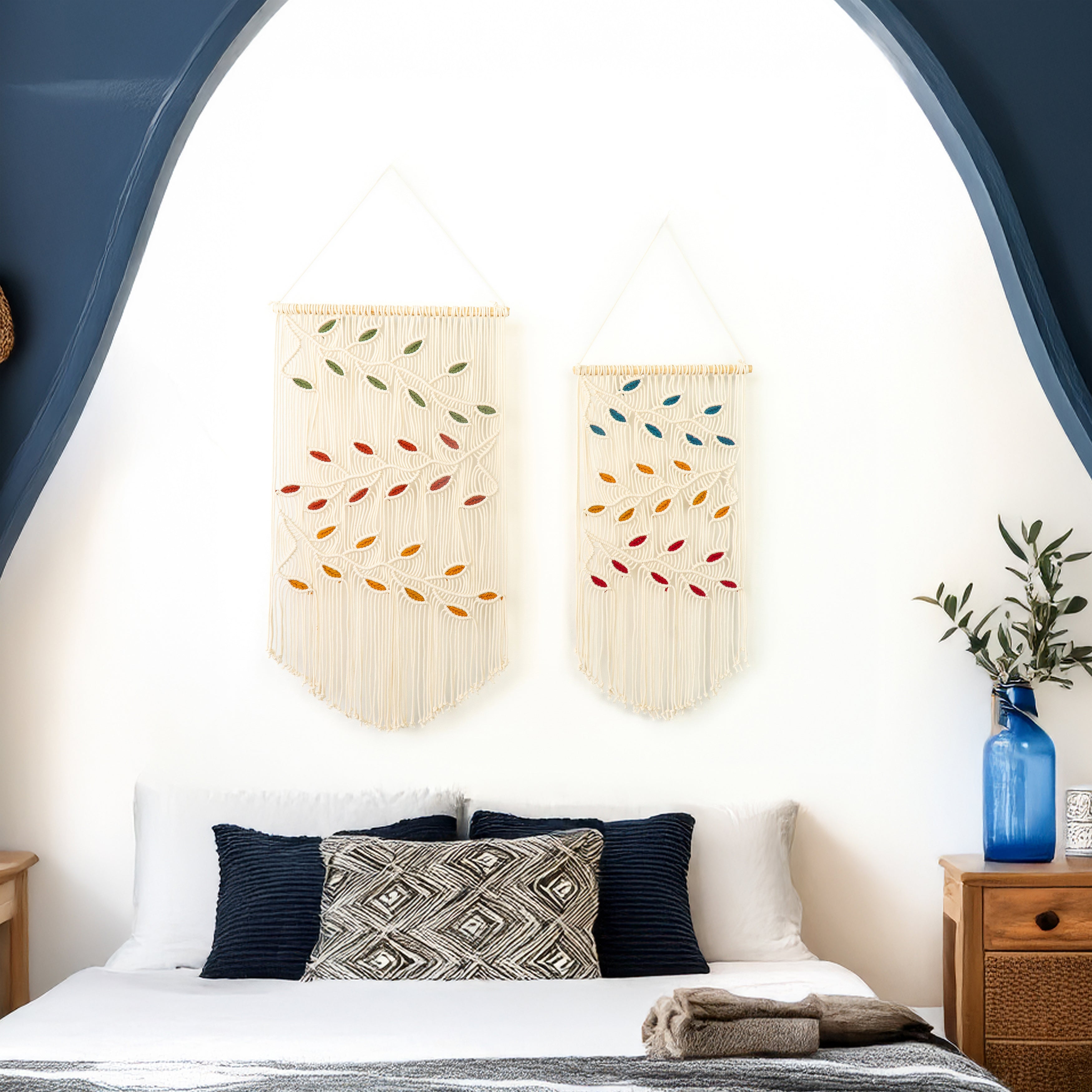 Decorative wall hangings with colorful patterns above a bed in a bedroom setting.