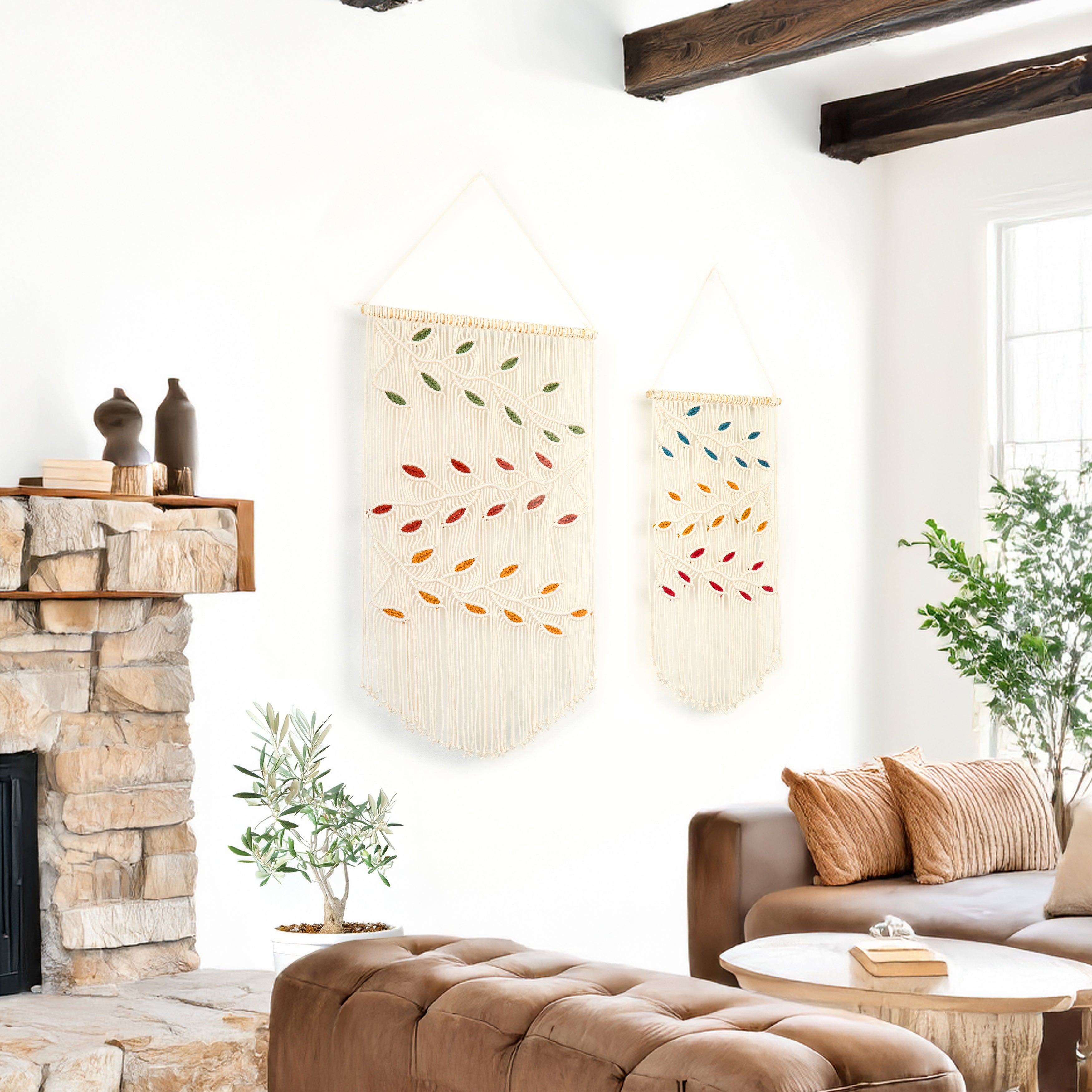 Living room with stone fireplace, brown ottoman, and decorative wall hangings.