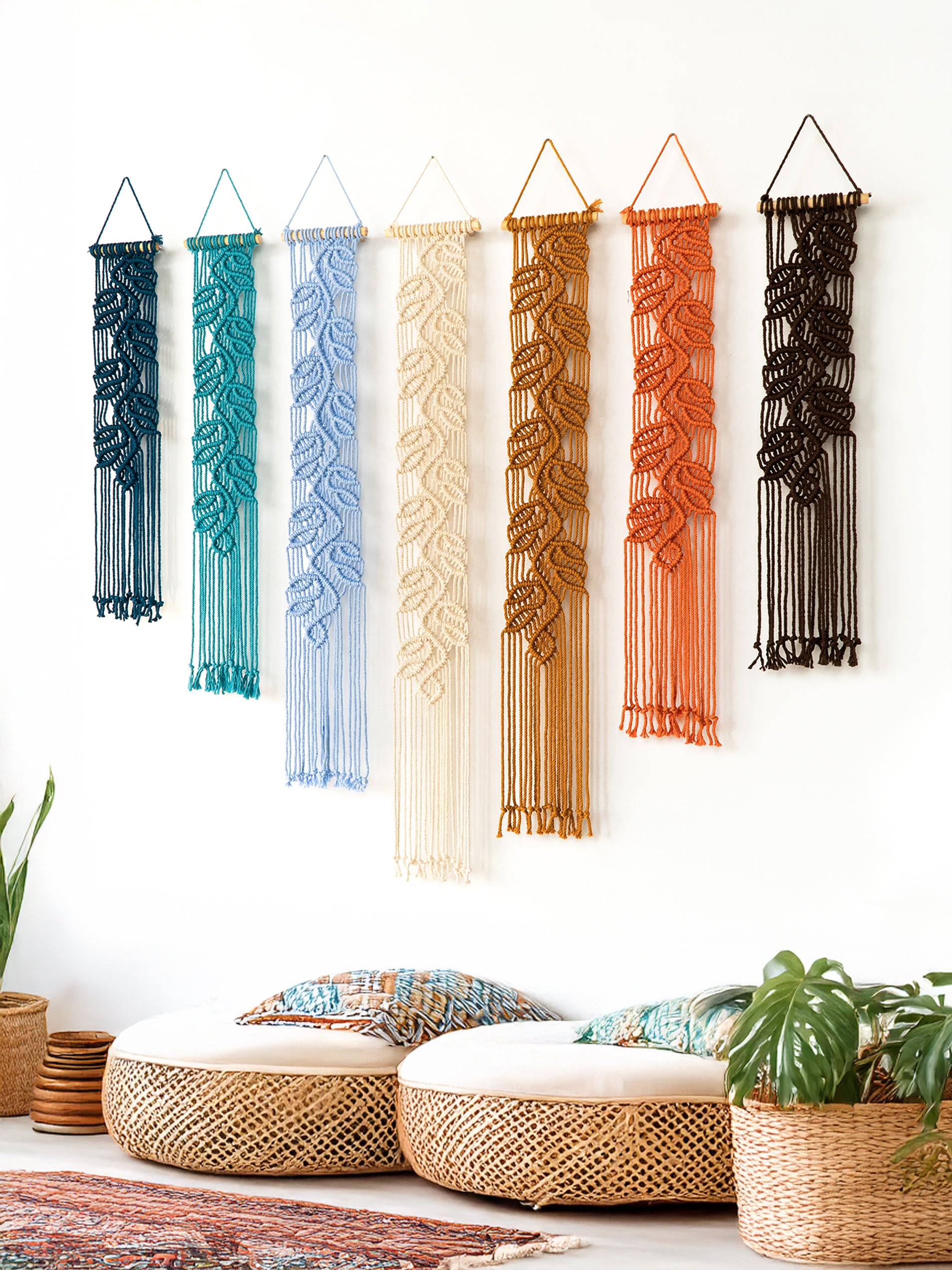 Set of custom macrame leaf tapestries with long fringe, showing a color progression from deep navy blue to dark brown.