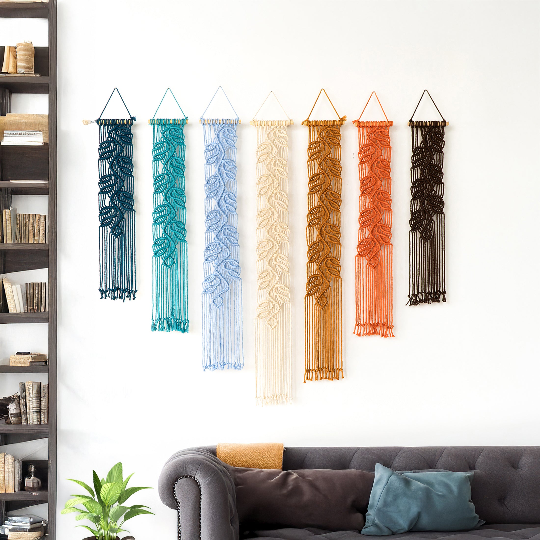 Artisan-made vertical macrame banners featuring a detailed botanical relief design in thick, custom-dyed cotton rope.
