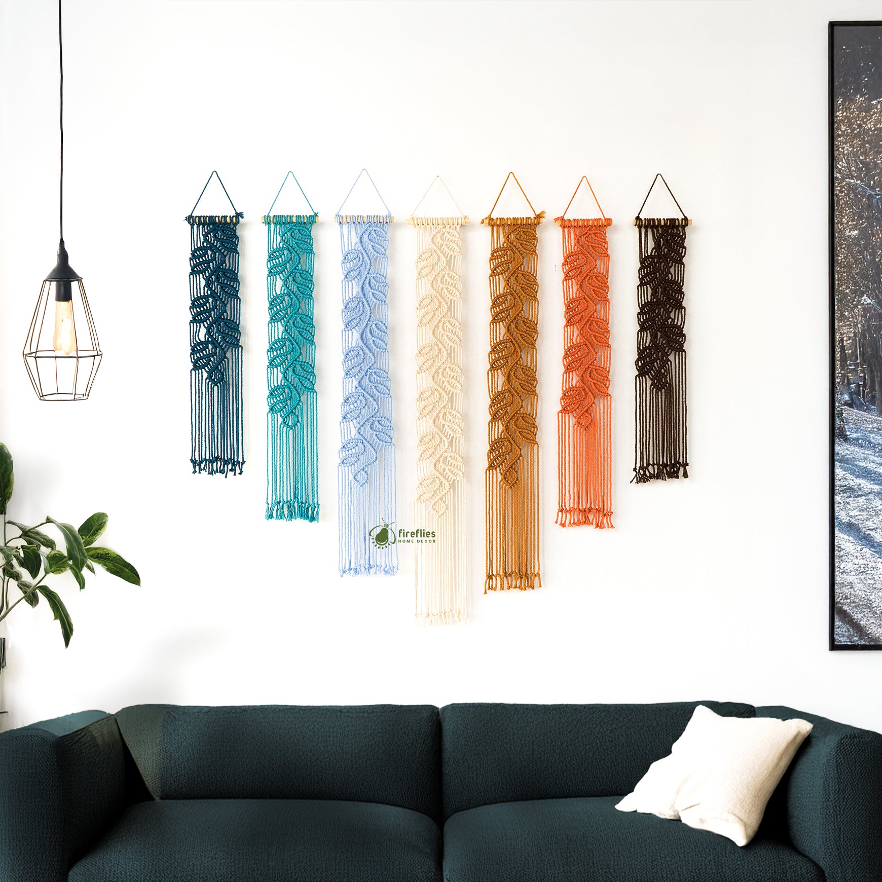 Three wall hangings with leaf patterns in a living room setting.