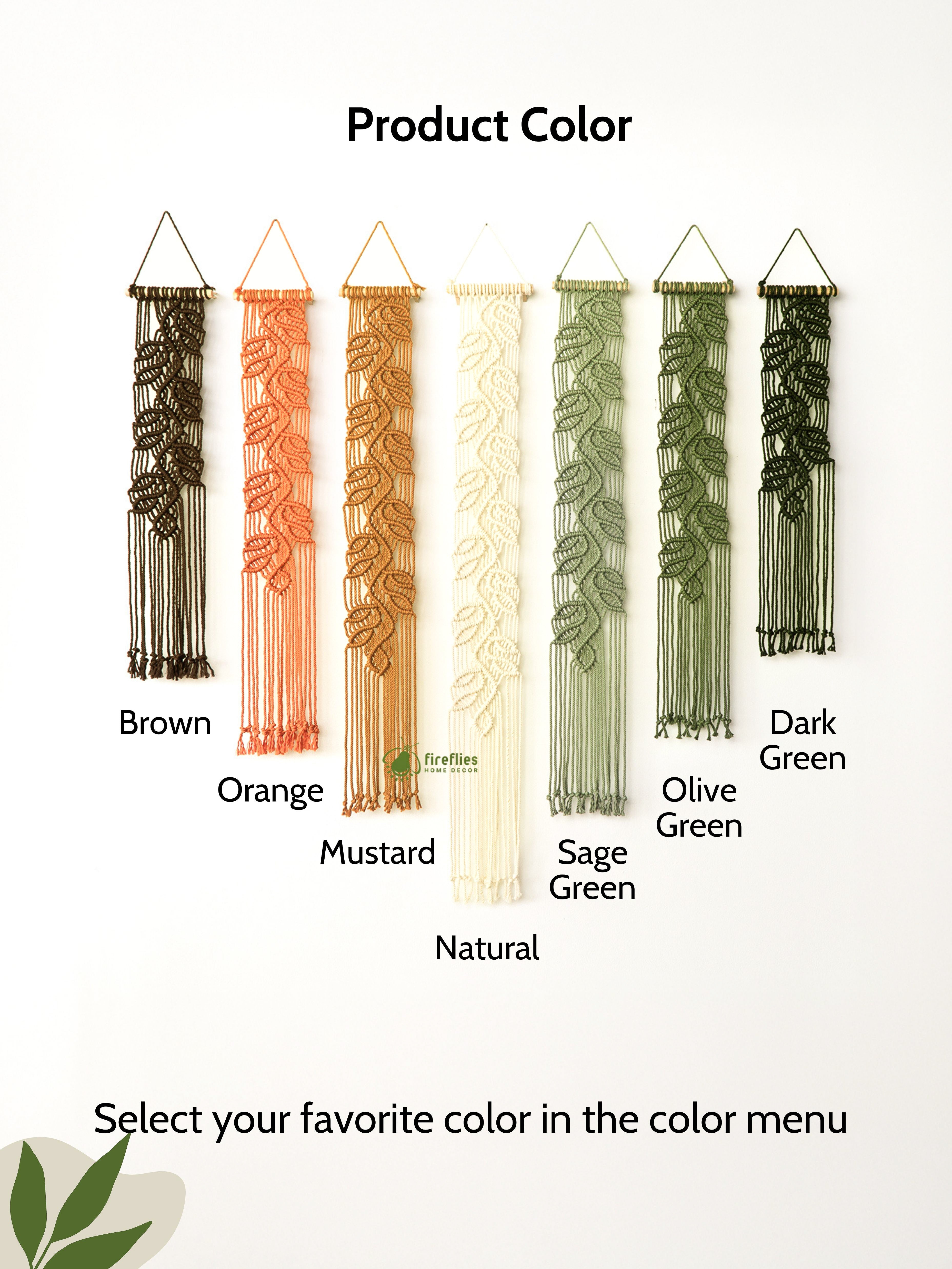 Custom macrame wall decor for a living room: long, narrow leaf-patterned banners creating a textured gallery wall.