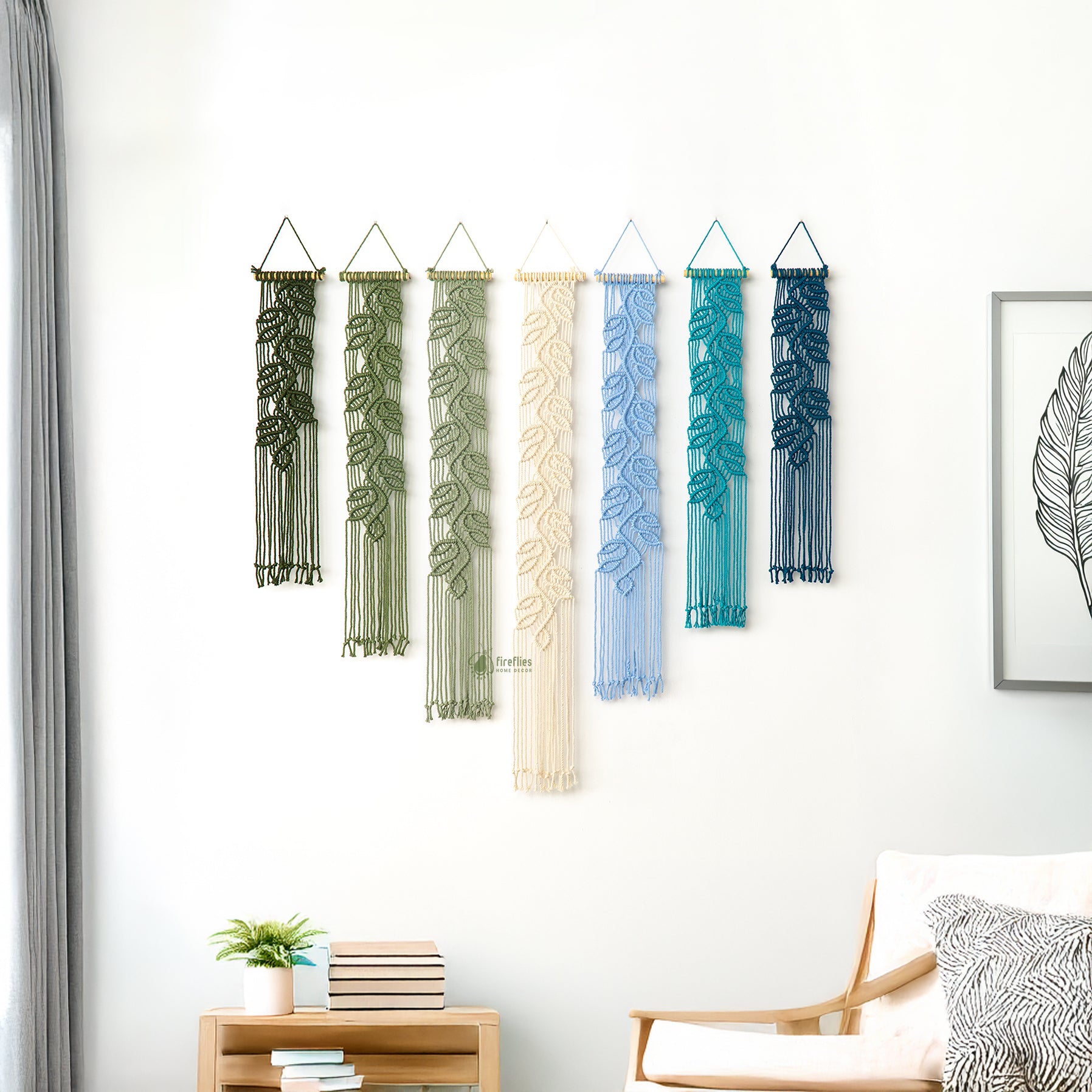 Bohemian textile wall art set of seven pieces with a detailed sculptural leaf design, enhancing a neutral seating area.