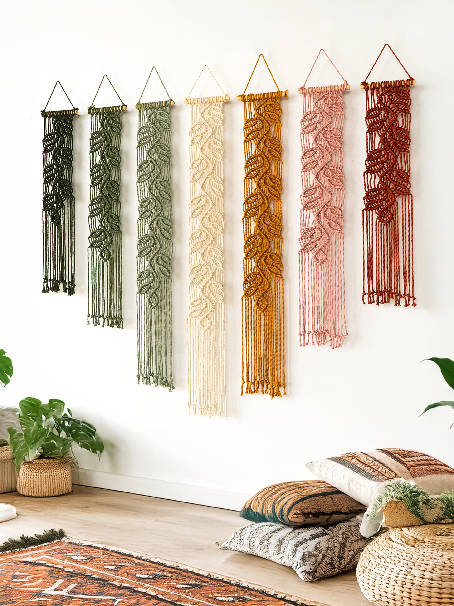 Set of custom macrame leaf tapestries showing a color progression from dark green to rust, perfect for boho home decor.