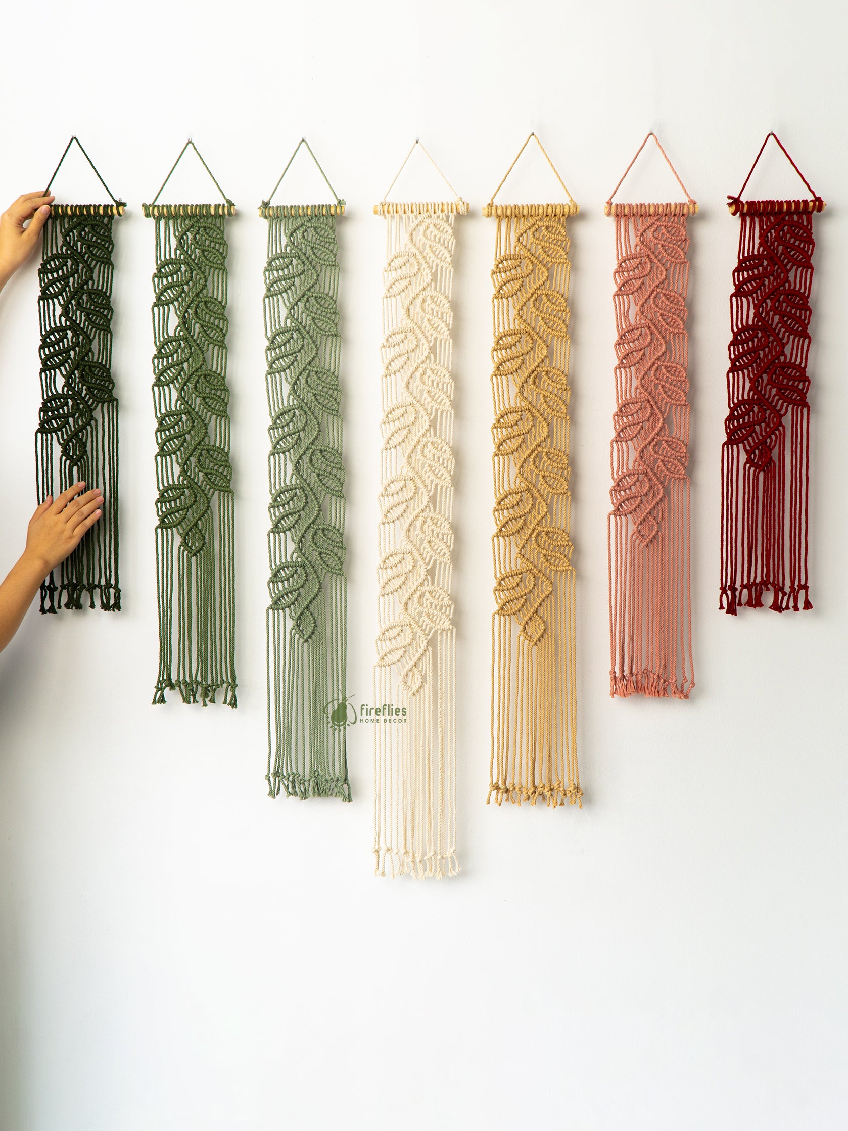 Set of six woven wall art pieces in various colors on a white background