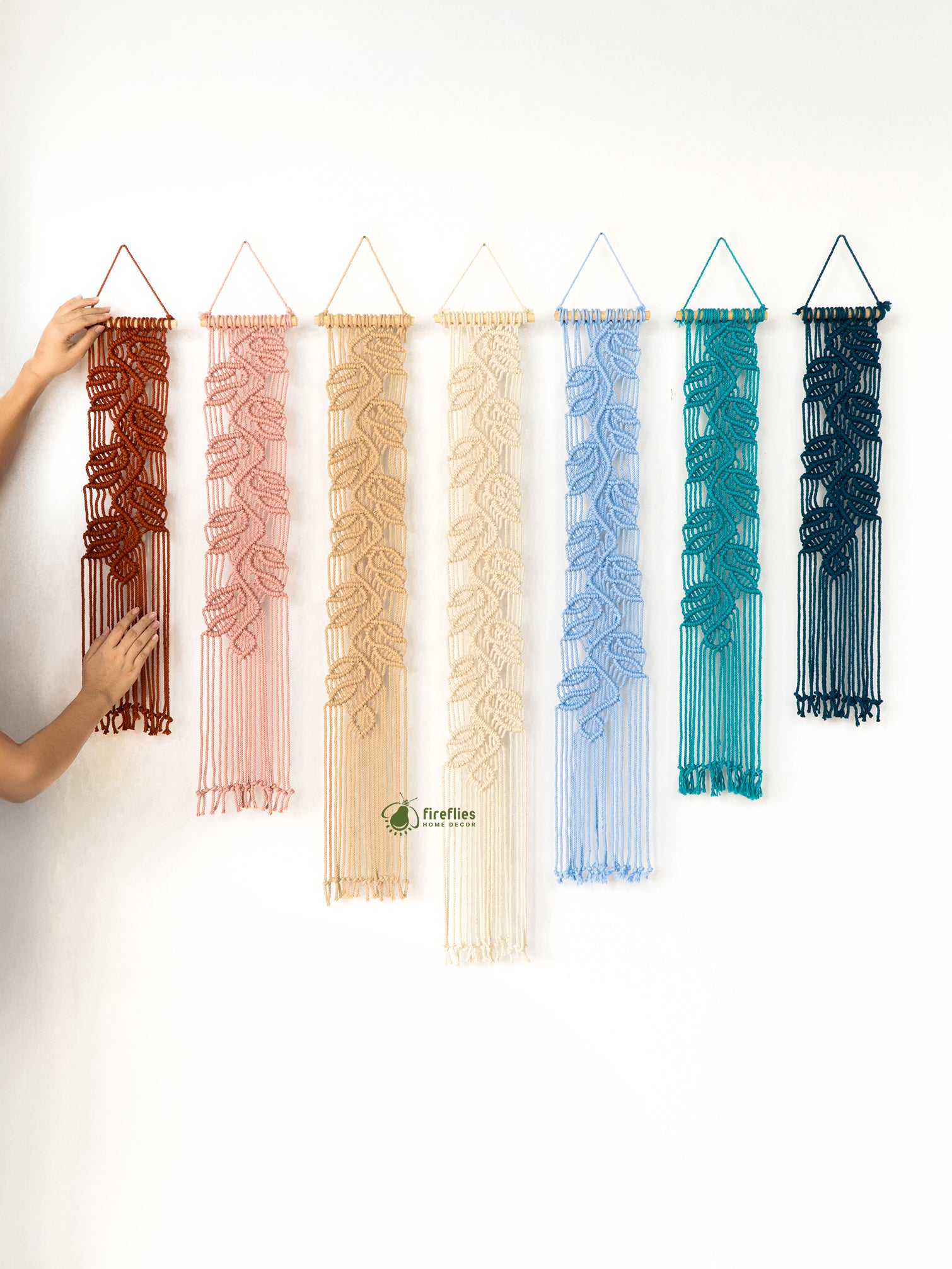 Set of colorful woven wall hangings on a white background