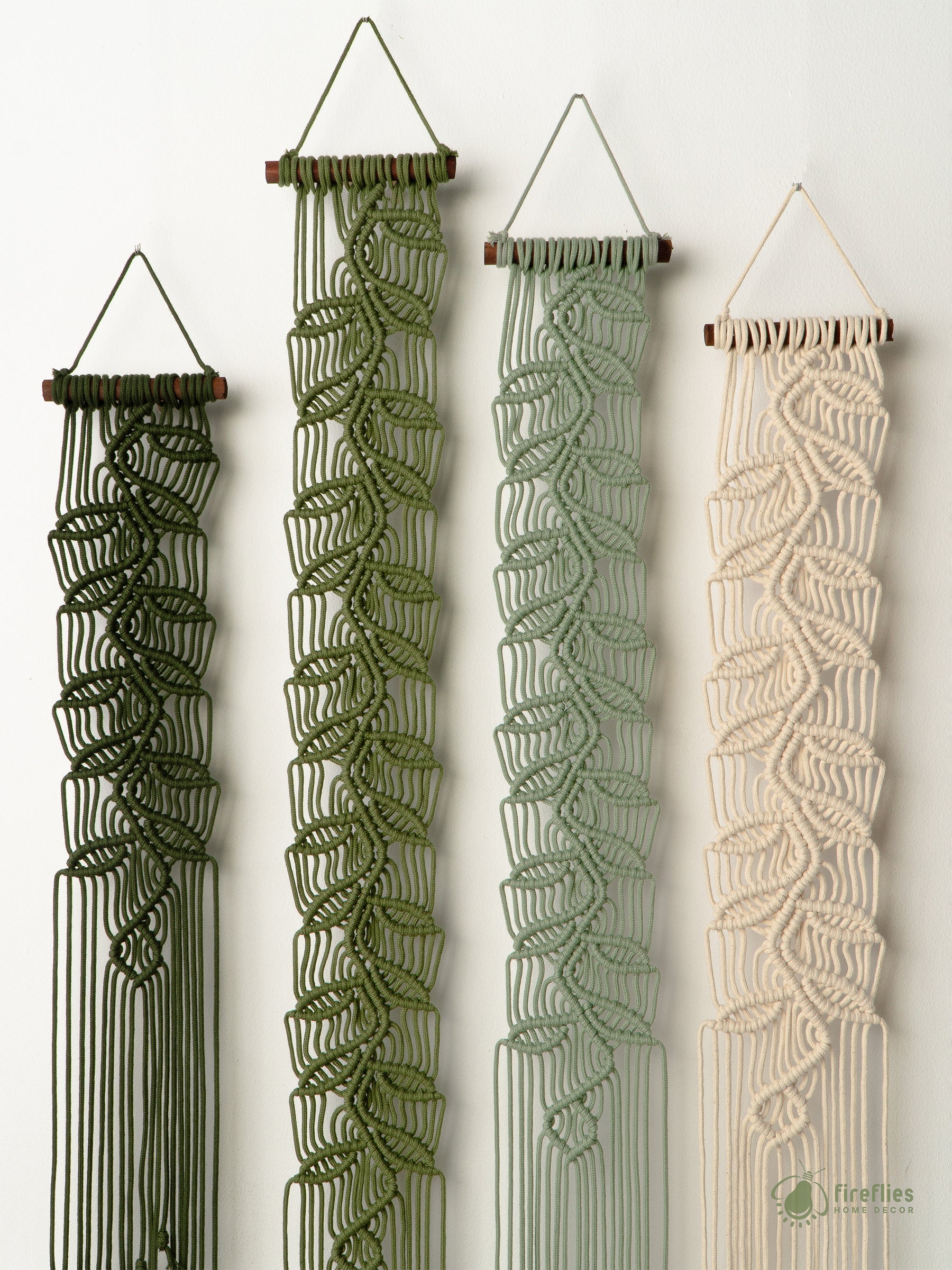 Textured red wall hanging on a white wall with a plant and basket in the foreground.
